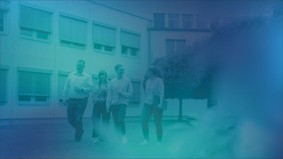 Foto von vier DVZ-Kolleg*innen im Innenhof gehend, blau eingefärbt