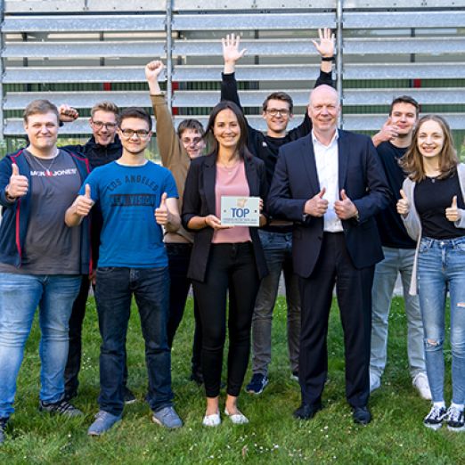Foto: Kolleg*innen der Personalabteilung und die Auszubildenden mit der Plakette TOP-Ausbildungsbetrieb 2022